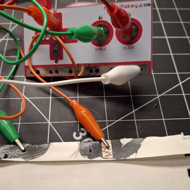 The problem I ran into with the previous posters with the paint mixture I used since it was mixed with an uneven ratio. Because of this I had to scrap most of the previous posters, but I still tested the hand one, using copper tape for the circuit.